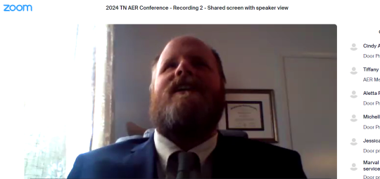 Brad Blair on-screen in a Zoom recording of his keynote address at the 2024 Tennessee AER Conference. Brad has a beard and is wearing a blue jacket and tie with a white shirt.