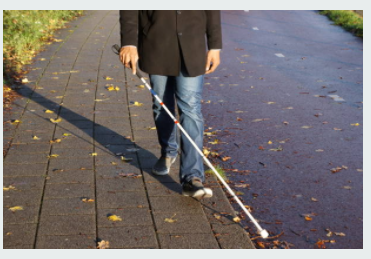 picture of man walking with a white cane